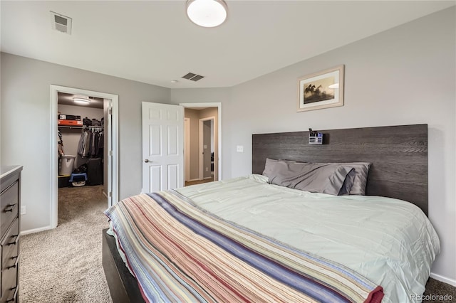 bedroom featuring carpet, a spacious closet, and a closet