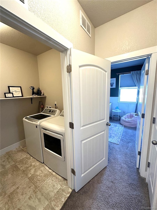 6834 Clay St N, Denver, CO 80221 - laundry area with washer and dryer, a textured ceiling, a textured wall, and light carpet