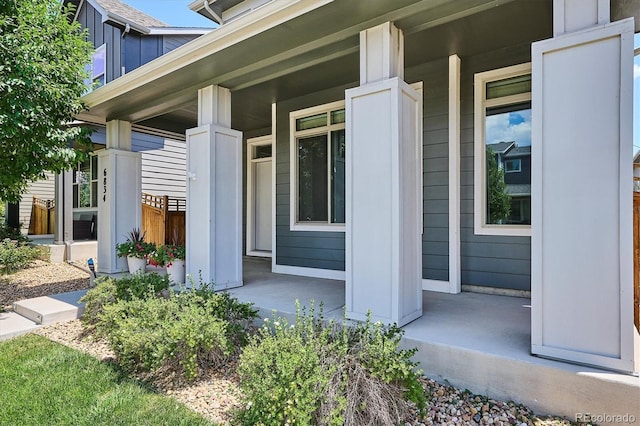 6834 Clay St N, Denver, CO 80221 - doorway to property with covered porch and board and batten siding