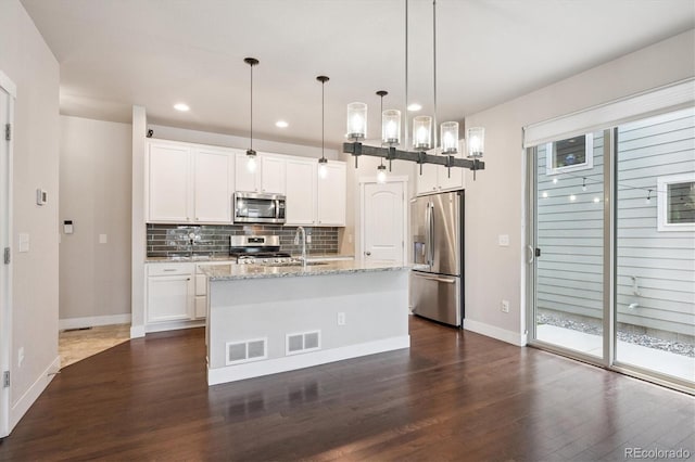 6834 Clay St N, Denver, CO 80221 - kitchen featuring stainless steel appliances, dark wood finished floors, decorative backsplash, recessed lighting, and light stone countertops