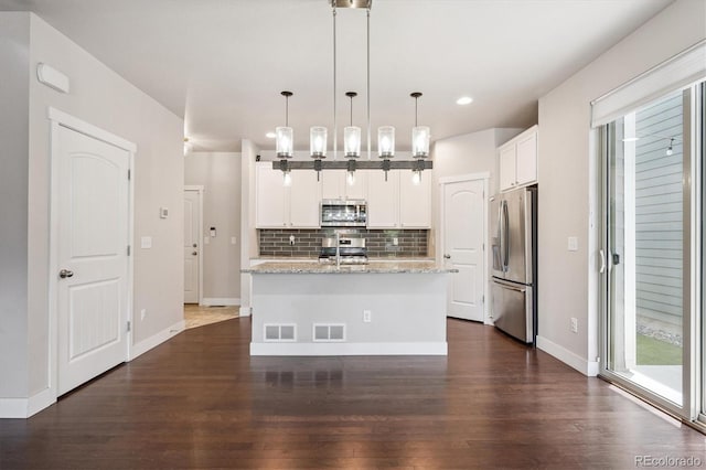 6834 Clay St N, Denver, CO 80221 - kitchen featuring appliances with stainless steel finishes, backsplash, white cabinetry, dark wood-style flooring, and recessed lighting