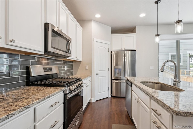 6834 Clay St N, Denver, CO 80221 - kitchen with stainless steel appliances, dark wood-style flooring, backsplash, white cabinets, and recessed lighting