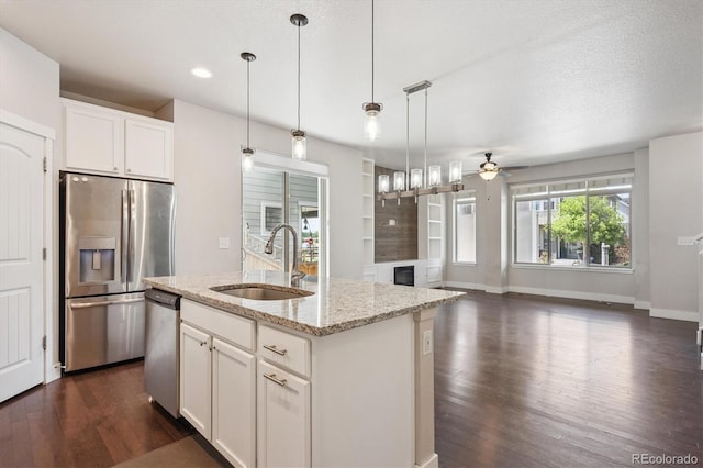 6834 Clay St N, Denver, CO 80221 - kitchen featuring stainless steel appliances, open floor plan, dark wood-style floors, a ceiling fan, and light stone counters