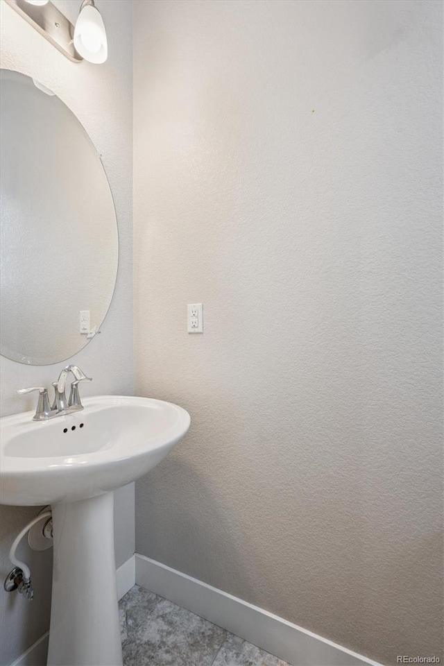 6834 Clay St N, Denver, CO 80221 - bathroom featuring baseboards and a sink