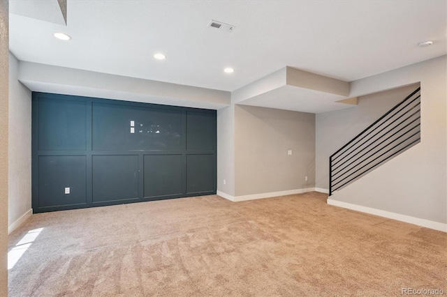 6834 Clay St N, Denver, CO 80221 - unfurnished living room with light colored carpet, recessed lighting, and stairway