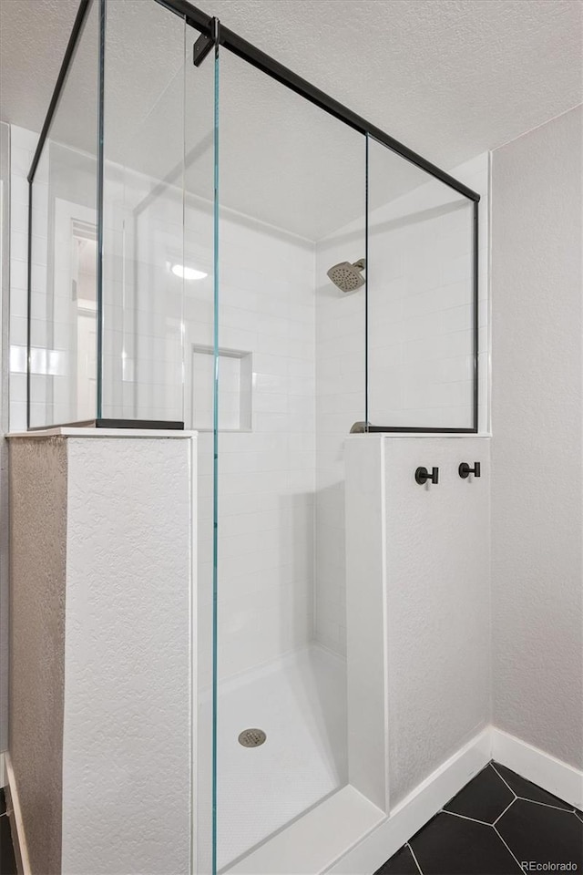 6834 Clay St N, Denver, CO 80221 - full bath with a shower stall, tile patterned floors, a textured ceiling, and a textured wall