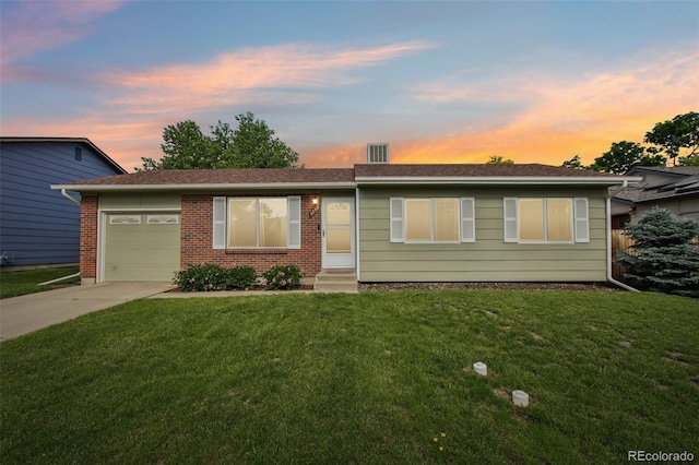4759 S Xenophon St, Morrison, CO 80465 - ranch-style home featuring concrete driveway, a garage, a front lawn, entry steps, and brick siding