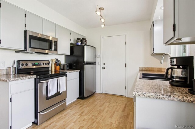 4759 S Xenophon St, Morrison, CO 80465 - kitchen featuring appliances with stainless steel finishes and light wood-style floors