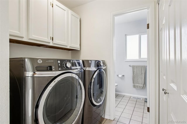 4759 S Xenophon St, Morrison, CO 80465 - washroom featuring independent washer and dryer, cabinet space, and light tile patterned floors