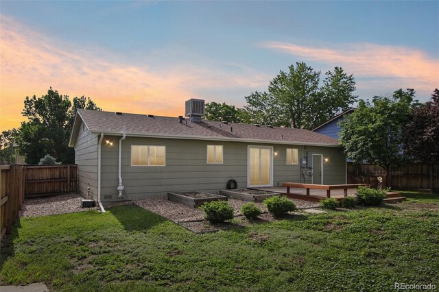 4759 S Xenophon St, Morrison, CO 80465 - rear view of house with a fenced backyard, a vegetable garden, a deck, and a shingled roof
