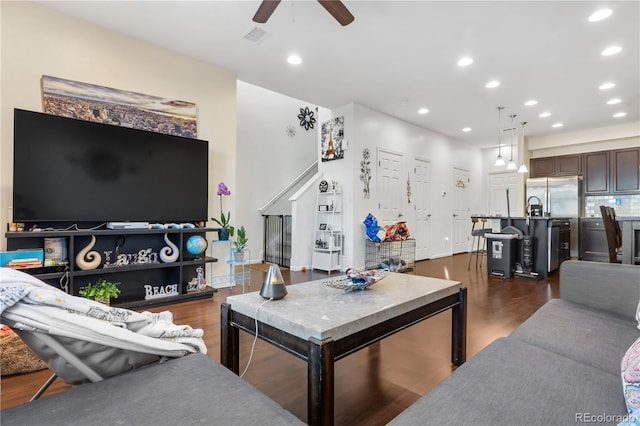 living room with ceiling fan and dark hardwood / wood-style floors