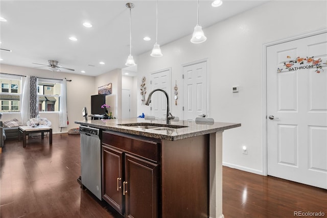 kitchen with stainless steel dishwasher, ceiling fan, a kitchen island with sink, sink, and pendant lighting