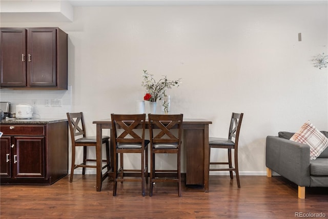 dining room with dark hardwood / wood-style floors