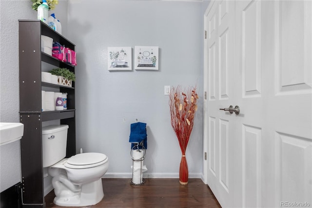 bathroom with wood-type flooring and toilet