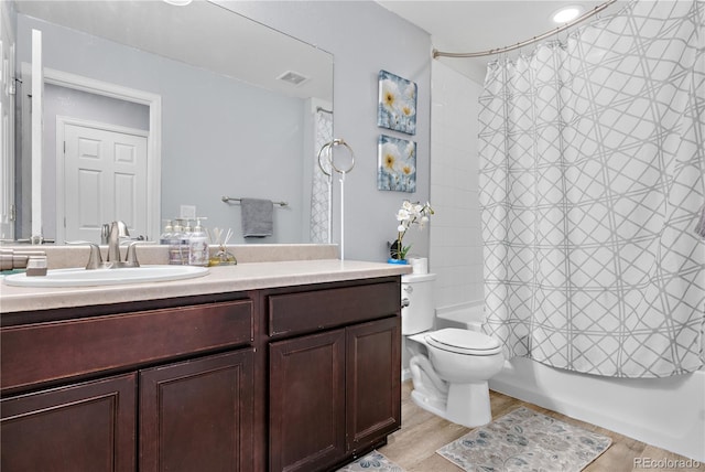 full bathroom featuring hardwood / wood-style floors, vanity, toilet, and shower / bathtub combination with curtain