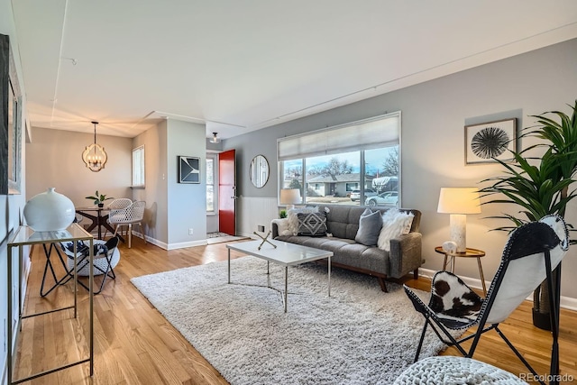 living room featuring an inviting chandelier and light hardwood / wood-style floors