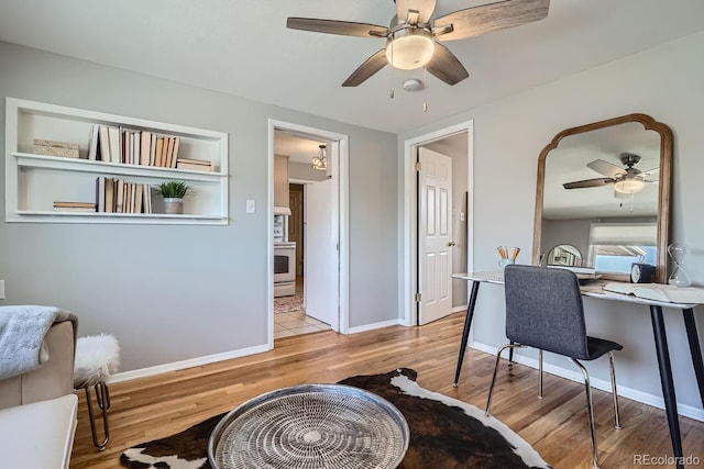 office featuring baseboards, wood finished floors, and a ceiling fan