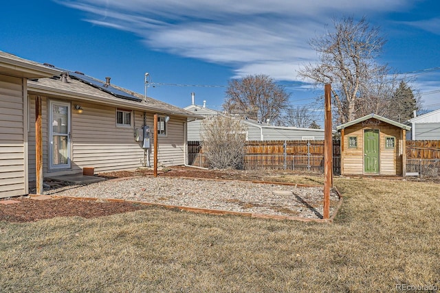 view of yard with an outbuilding, a storage unit, and fence