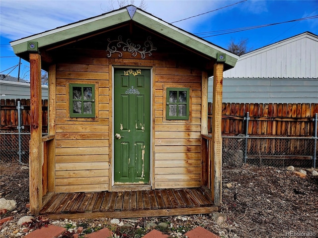 view of outbuilding featuring an outbuilding and fence