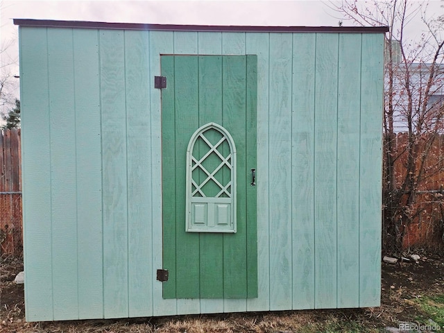 view of shed with fence