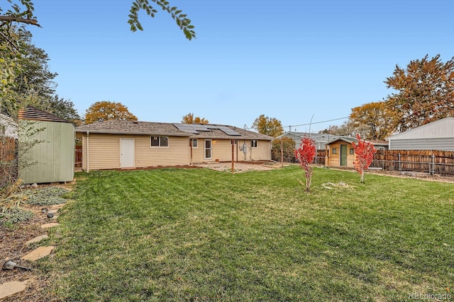 view of yard featuring an outdoor structure, fence, a shed, and a patio