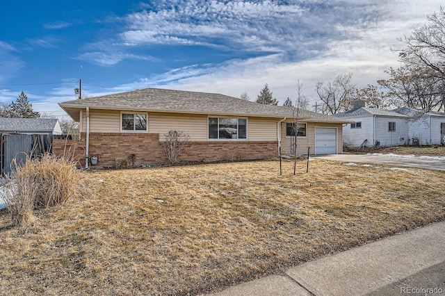 ranch-style home with brick siding, concrete driveway, and an attached garage