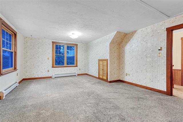 interior space featuring carpet, a baseboard heating unit, and a textured ceiling