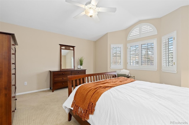 bedroom with light carpet, baseboards, a ceiling fan, and lofted ceiling