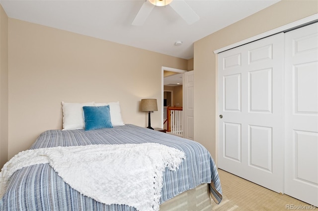 bedroom featuring ceiling fan, a closet, and carpet flooring