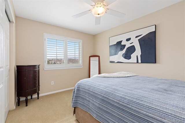 bedroom with a closet, carpet flooring, a ceiling fan, and baseboards