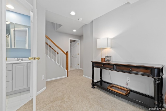 carpeted home office featuring baseboards, a sink, and recessed lighting