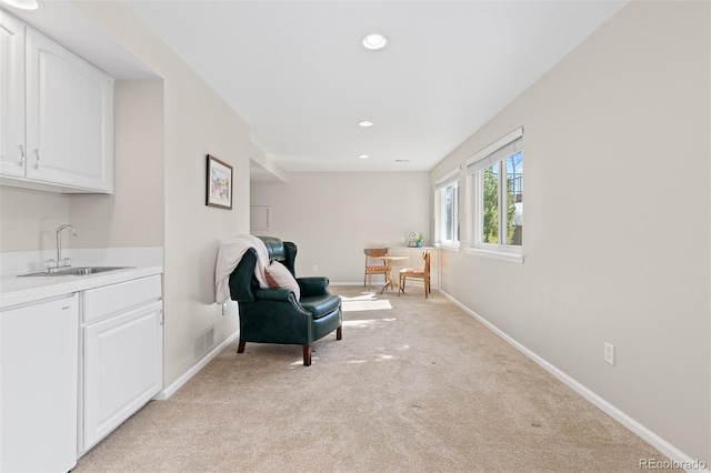 living area featuring recessed lighting, visible vents, light carpet, and baseboards