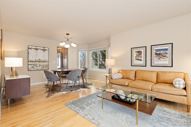 living room with light wood-type flooring and baseboards