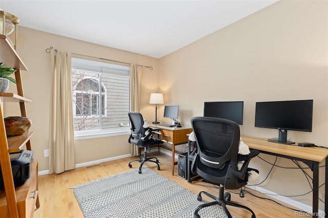 office space with wood finished floors and baseboards