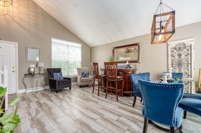 interior space with high vaulted ceiling and baseboards