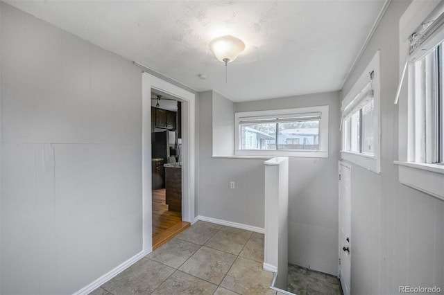 laundry area with light tile patterned floors
