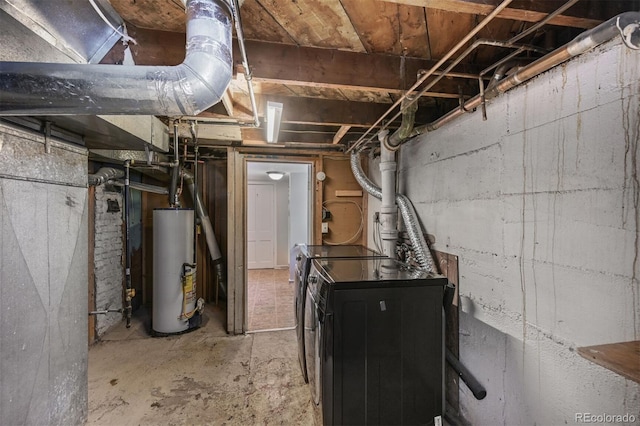 unfinished basement with gas water heater and separate washer and dryer