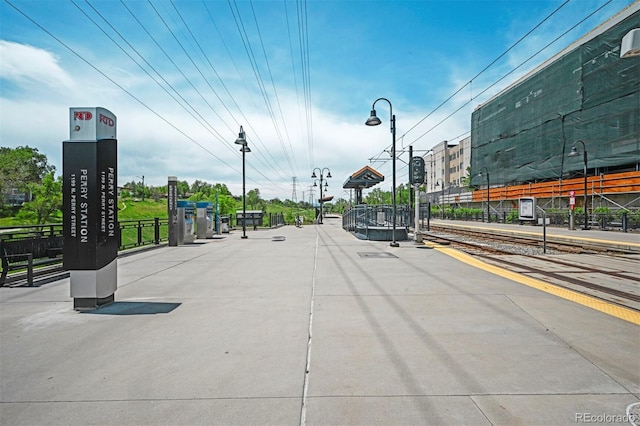 view of street featuring street lights and curbs