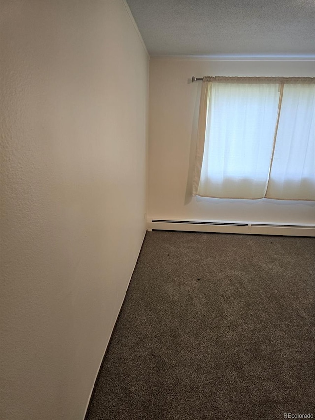 unfurnished room featuring baseboard heating, a textured ceiling, and carpet floors