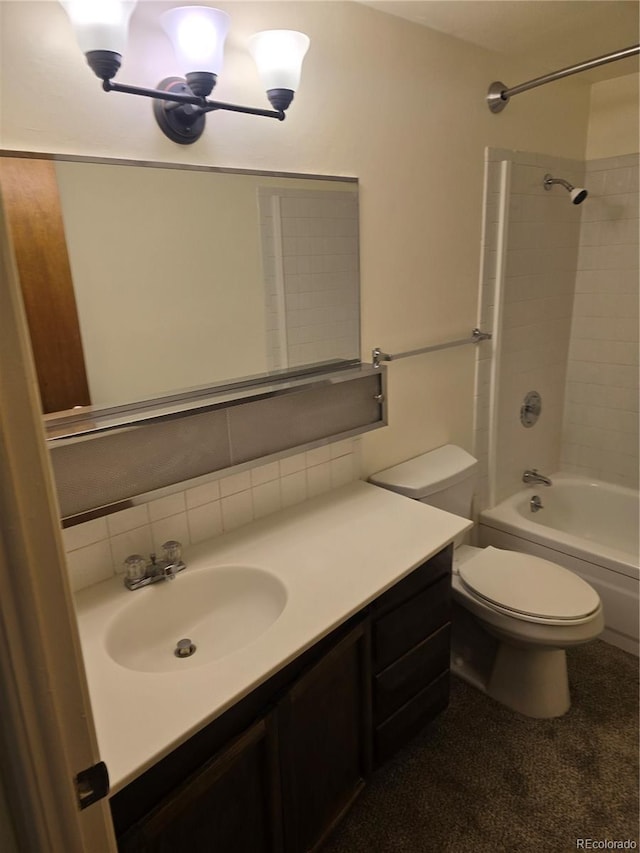 full bathroom with vanity, toilet, and tiled shower / bath