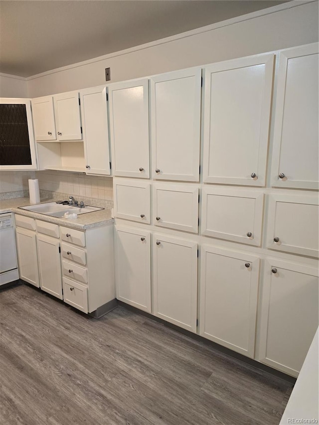 kitchen featuring white cabinets, dark wood-type flooring, dishwasher, and sink