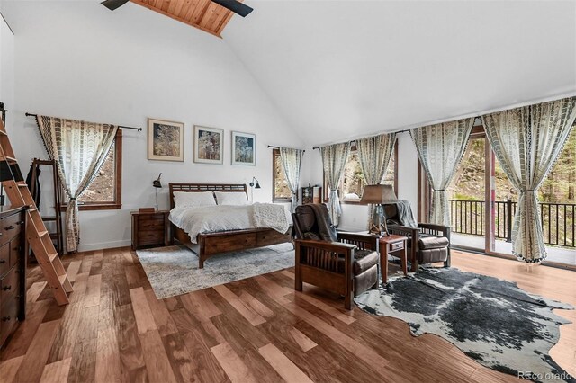 663 Brookside Dr, Bailey, CO 80421 - bedroom with high vaulted ceiling, access to exterior, and wood finished floors