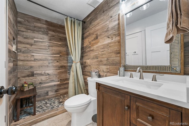 663 Brookside Dr, Bailey, CO 80421 - full bathroom featuring wood walls, vanity, a tile shower, and tile patterned flooring