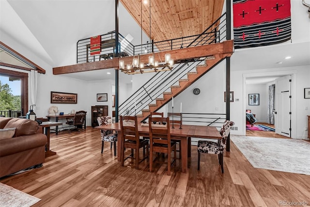 663 Brookside Dr, Bailey, CO 80421 - dining room featuring high vaulted ceiling, stairway, wood finished floors, a chandelier, and recessed lighting