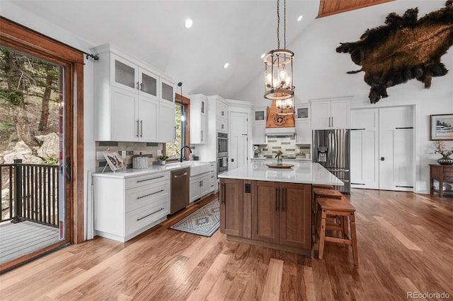 663 Brookside Dr, Bailey, CO 80421 - kitchen featuring stainless steel appliances, light countertops, a chandelier, decorative backsplash, and healthy amount of natural light