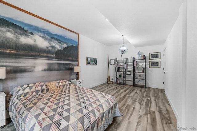 663 Brookside Dr, Bailey, CO 80421 - bedroom featuring wood finished floors, a water view, and a chandelier