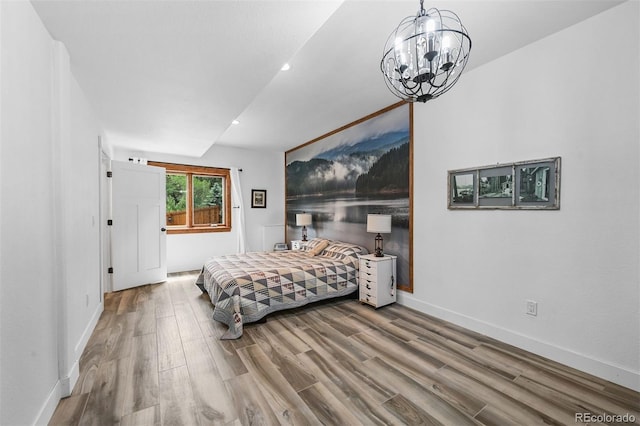 663 Brookside Dr, Bailey, CO 80421 - bedroom featuring wood finished floors, a chandelier, and recessed lighting