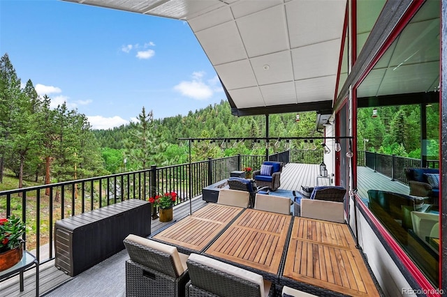 663 Brookside Dr, Bailey, CO 80421 - wooden deck with a wooded view