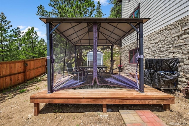 663 Brookside Dr, Bailey, CO 80421 - wooden deck with a storage unit and outdoor dining area