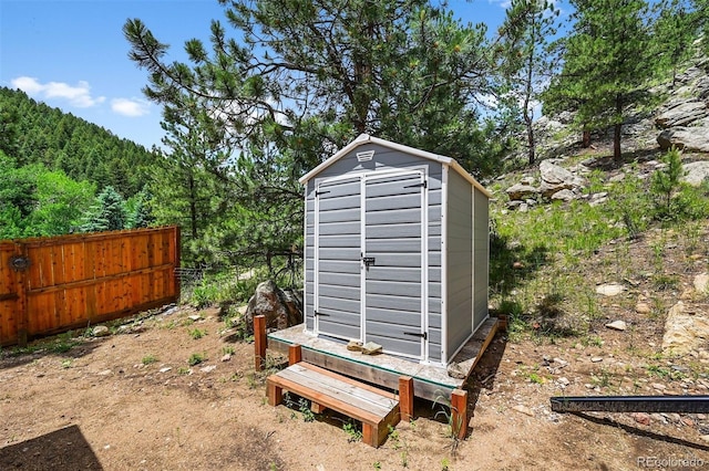 663 Brookside Dr, Bailey, CO 80421 - view of shed with a wooded view